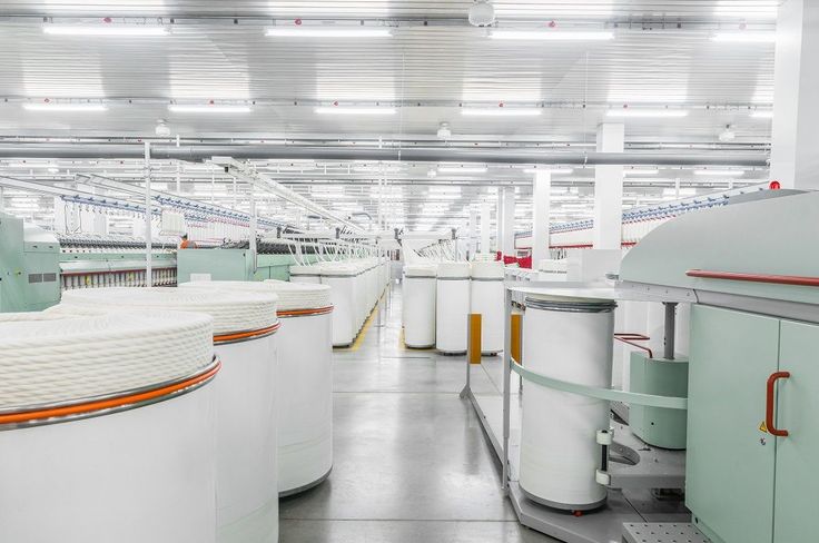 Modern rotor spinning machine in operation, producing high-quality yarn